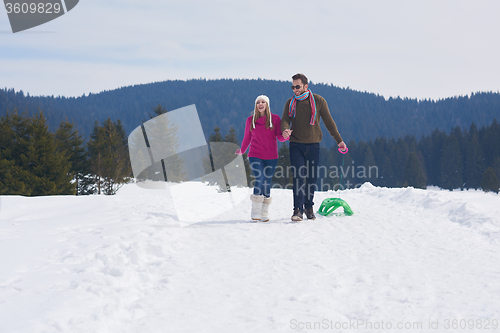 Image of happy young couple having fun on fresh show on winter vacation