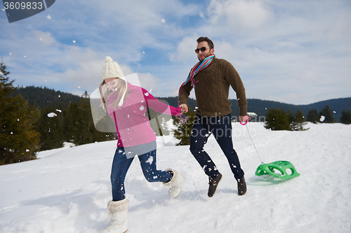 Image of happy young couple having fun on fresh show on winter vacation