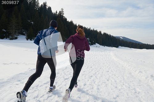 Image of couple jogging outside on snow