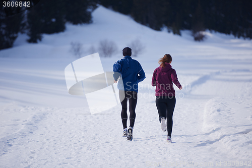 Image of couple jogging outside on snow