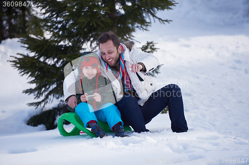 Image of couple having fun and walking in snow shoes