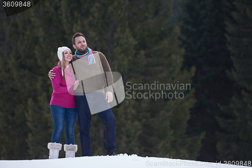 Image of couple having fun and walking in snow shoes