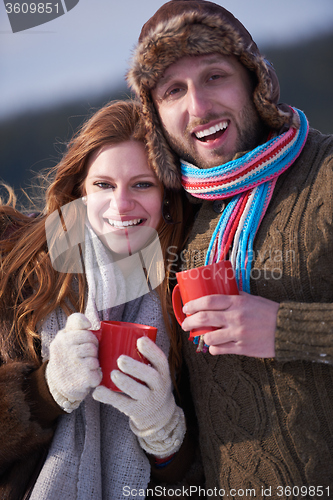 Image of couple drink warm tea at winter