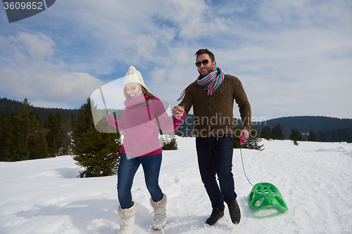 Image of happy young couple having fun on fresh show on winter vacation