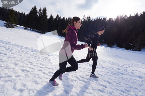 Image of couple jogging outside on snow