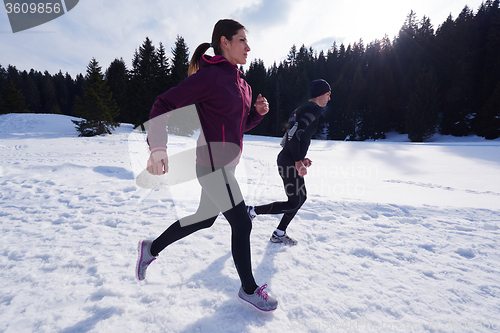 Image of couple jogging outside on snow