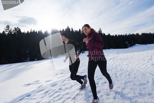 Image of couple jogging outside on snow