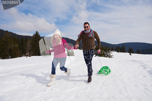 Image of happy young couple having fun on fresh show on winter vacation
