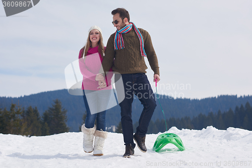 Image of happy young couple having fun on fresh show on winter vacation