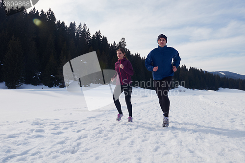 Image of couple jogging outside on snow