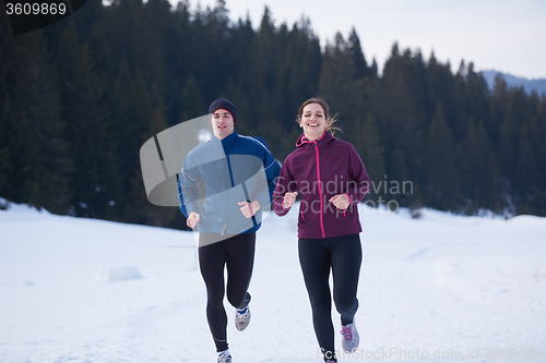 Image of couple jogging outside on snow