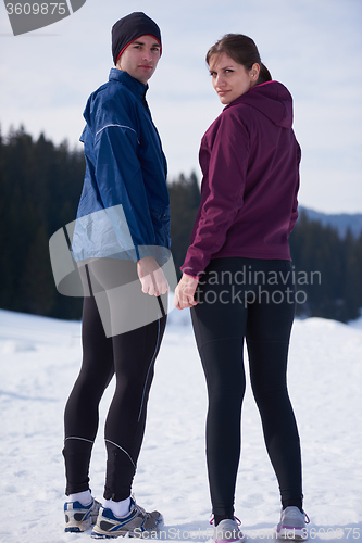 Image of couple jogging outside on snow