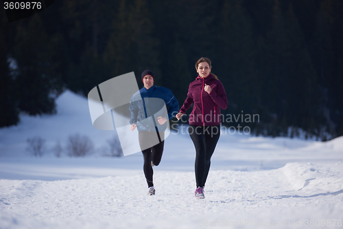 Image of couple jogging outside on snow