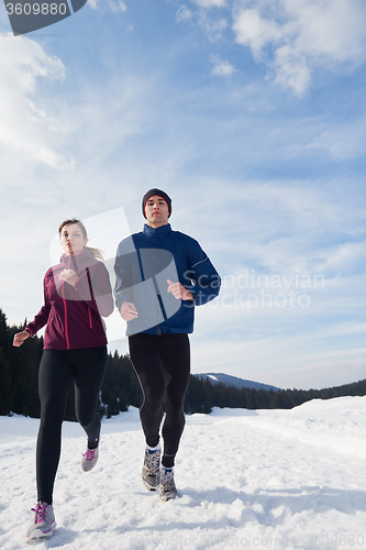 Image of couple jogging outside on snow