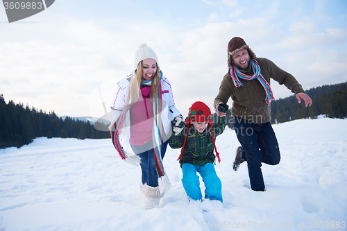 Image of happy family playing together in snow at winter