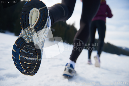 Image of couple jogging outside on snow