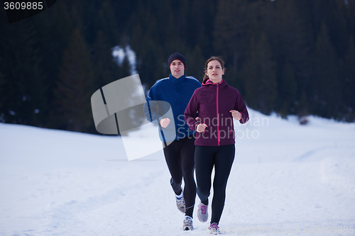 Image of couple jogging outside on snow
