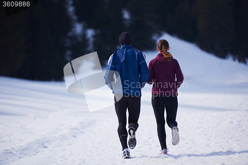 Image of couple jogging outside on snow