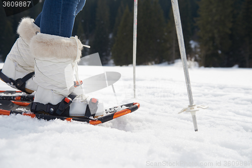 Image of couple having fun and walking in snow shoes