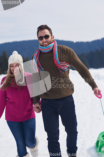 Image of happy young couple having fun on fresh show on winter vacation