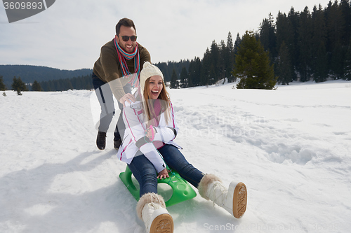 Image of happy young couple having fun on fresh show on winter vacation