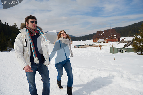 Image of happy young couple having fun on fresh show on winter vacation