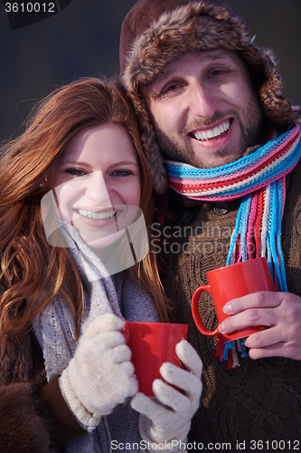 Image of couple drink warm tea at winter