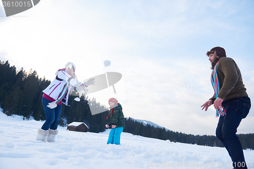 Image of happy family playing together in snow at winter