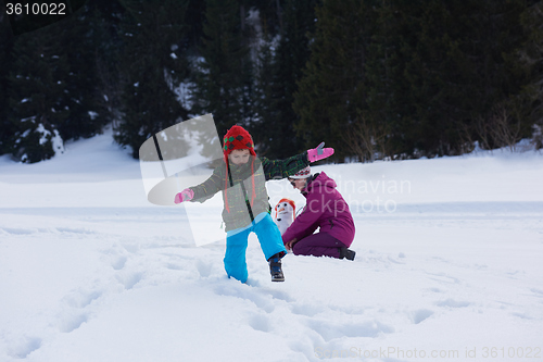 Image of happy family building snowman