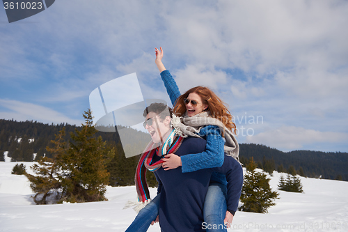 Image of happy young couple having fun on fresh show on winter vacation