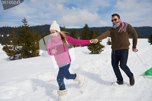 Image of happy young couple having fun on fresh show on winter vacation