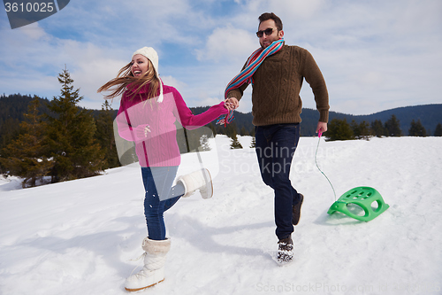 Image of happy young couple having fun on fresh show on winter vacation