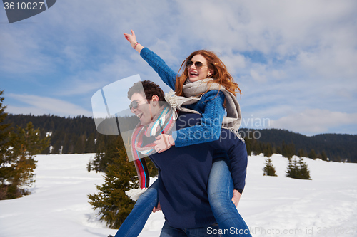 Image of happy young couple having fun on fresh show on winter vacation