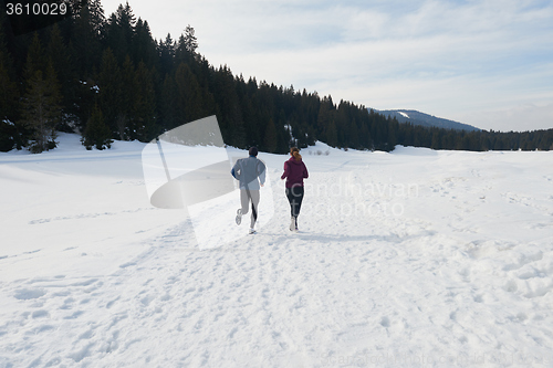 Image of couple jogging outside on snow