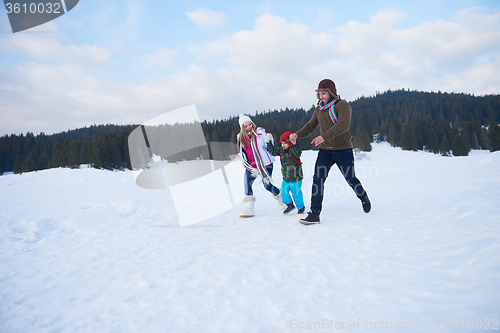 Image of happy family playing together in snow at winter