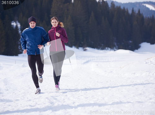Image of couple jogging outside on snow