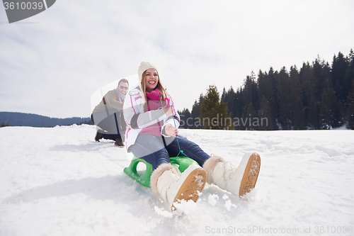 Image of happy young couple having fun on fresh show on winter vacation