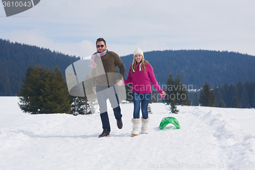 Image of happy young couple having fun on fresh show on winter vacation