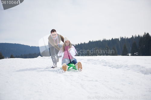 Image of happy young couple having fun on fresh show on winter vacation