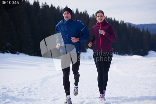 Image of couple jogging outside on snow