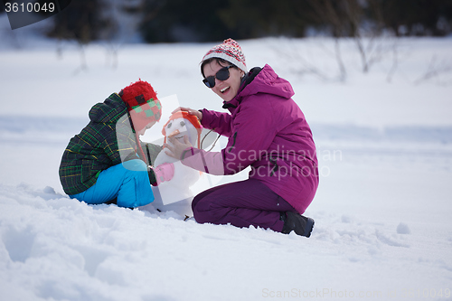 Image of happy family building snowman