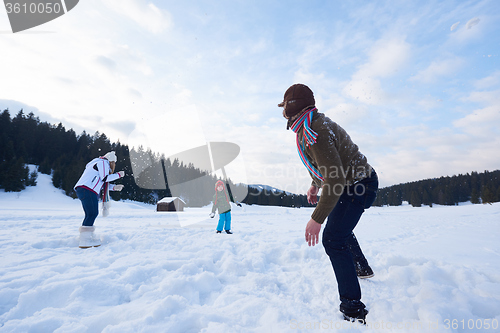 Image of happy family playing together in snow at winter