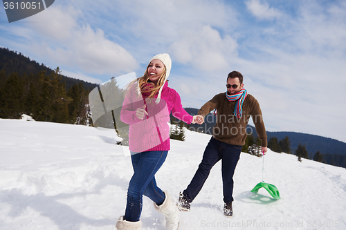 Image of happy young couple having fun on fresh show on winter vacation