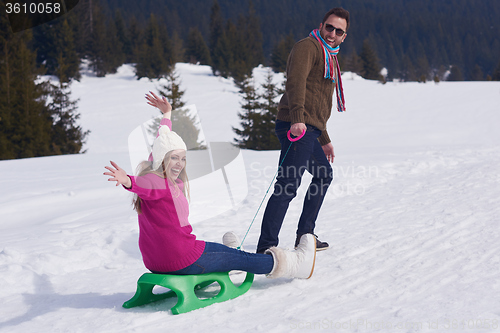 Image of happy young couple having fun on fresh show on winter vacation