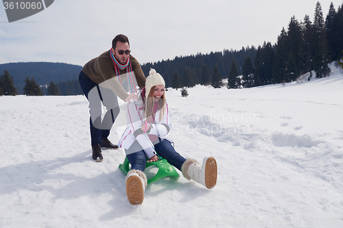 Image of happy young couple having fun on fresh show on winter vacation