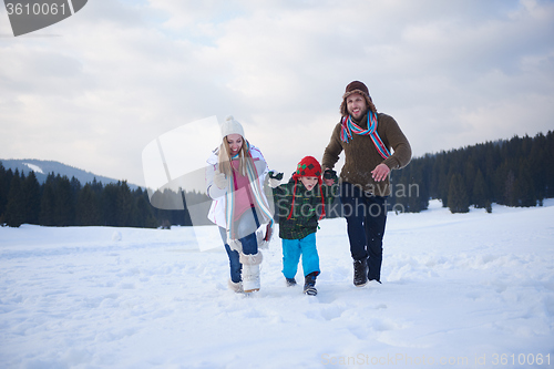 Image of happy family playing together in snow at winter