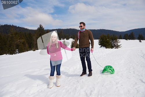 Image of happy young couple having fun on fresh show on winter vacation