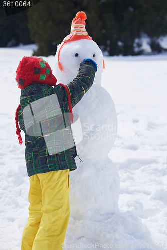 Image of boy making snowman