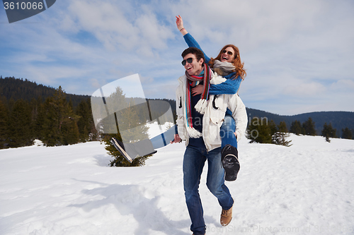 Image of happy young couple having fun on fresh show on winter vacation