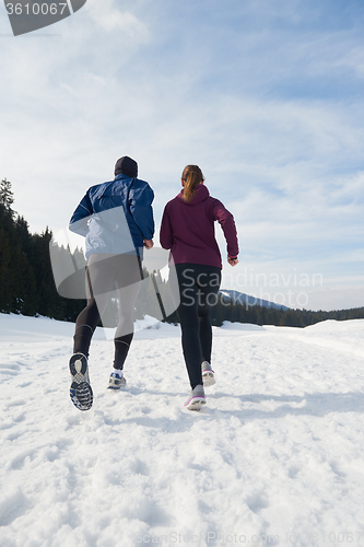 Image of couple jogging outside on snow